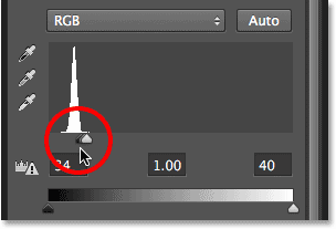 Dragging the black point slider towards the right. Image © 2013 Photoshop Essentials.com