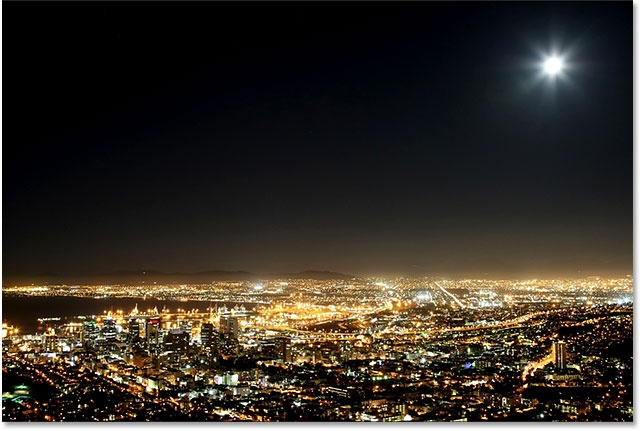 Cape Town harbor and city at night with moon in the sky. Image 59821666 licensed from Shutterstock by Photoshop Essentials.com